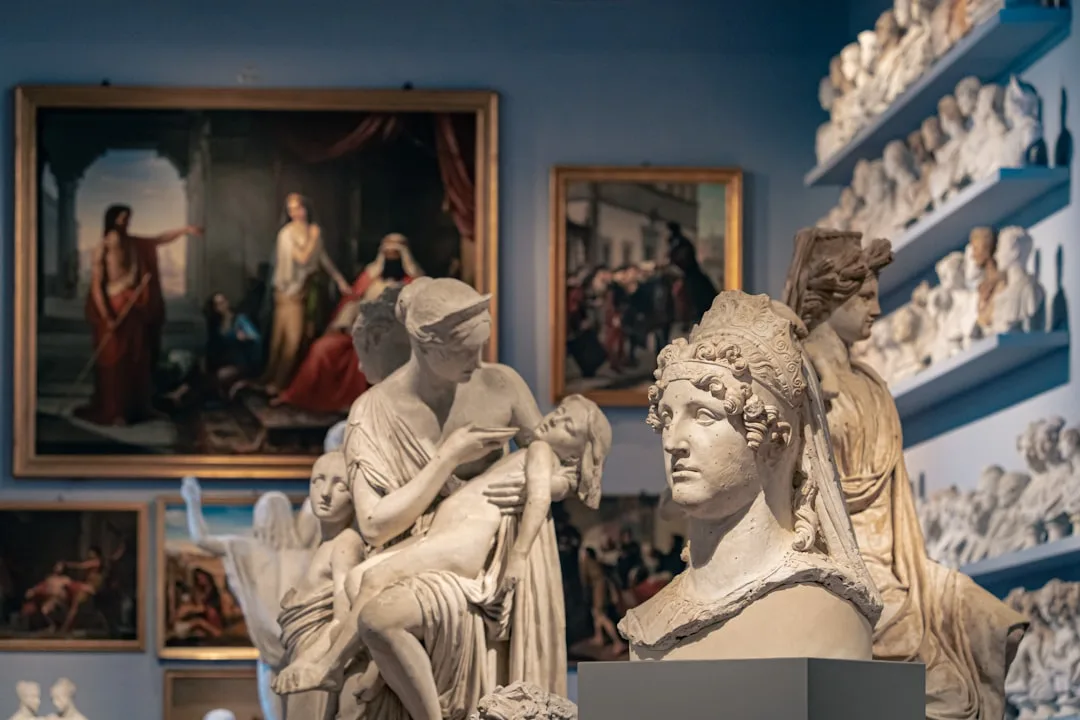 Ancient sculptures and paintings in a classical European art museum hall