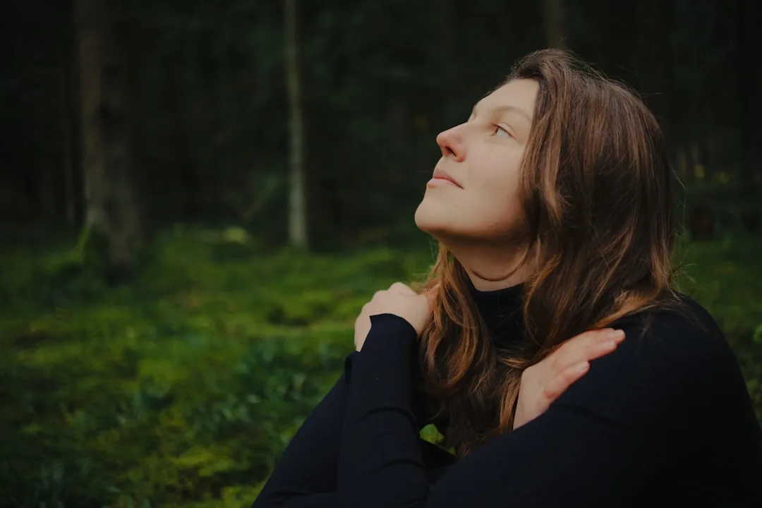 Woman with closed eyes enjoying stillness in a forest