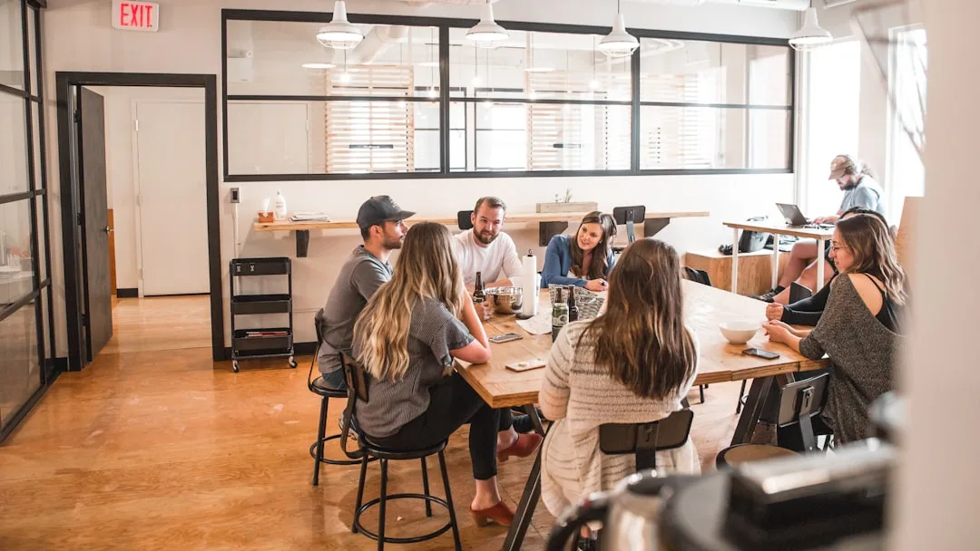 People having conversations at tables in a bright co-working café