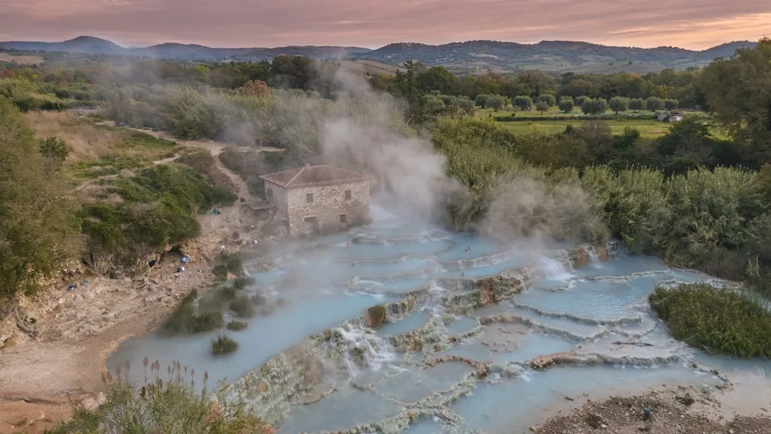 Dampfende Thermalquellen mit türkisblauem Wasser in toskanischer Landschaft