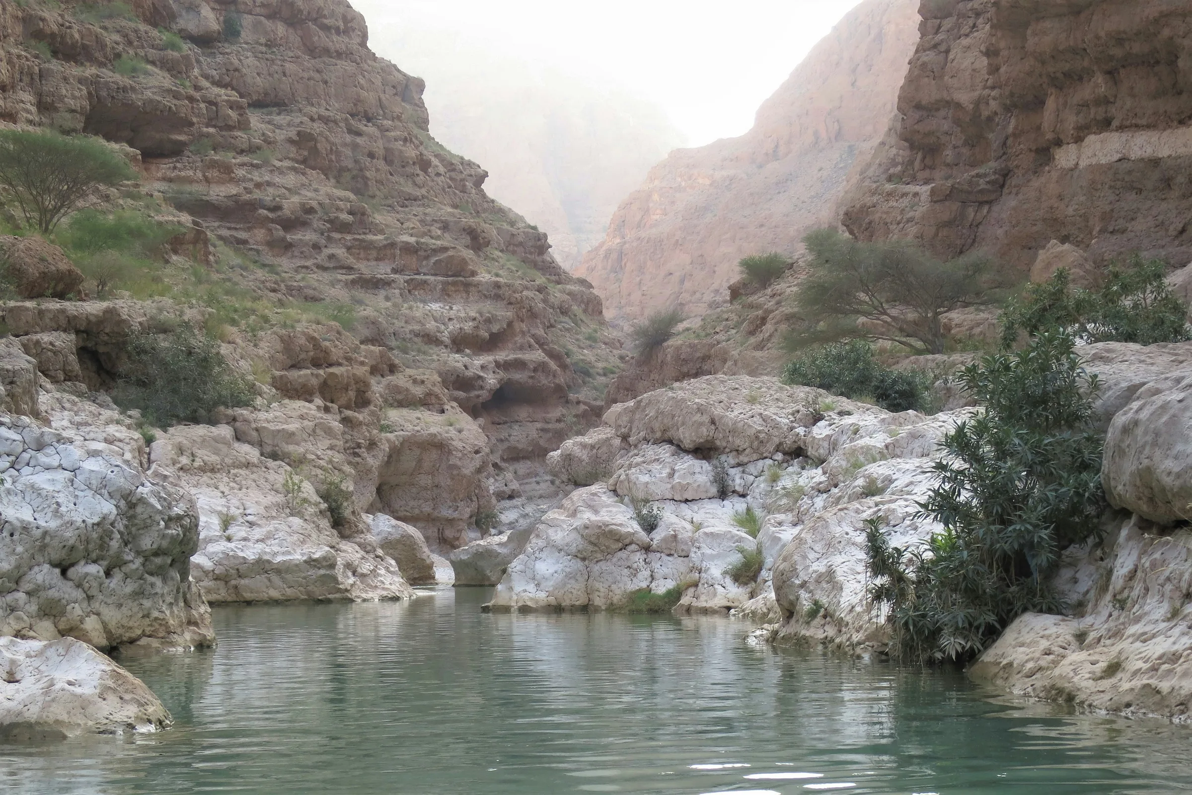Wadi Shab – turquoise pool surrounded by rocky cliffs