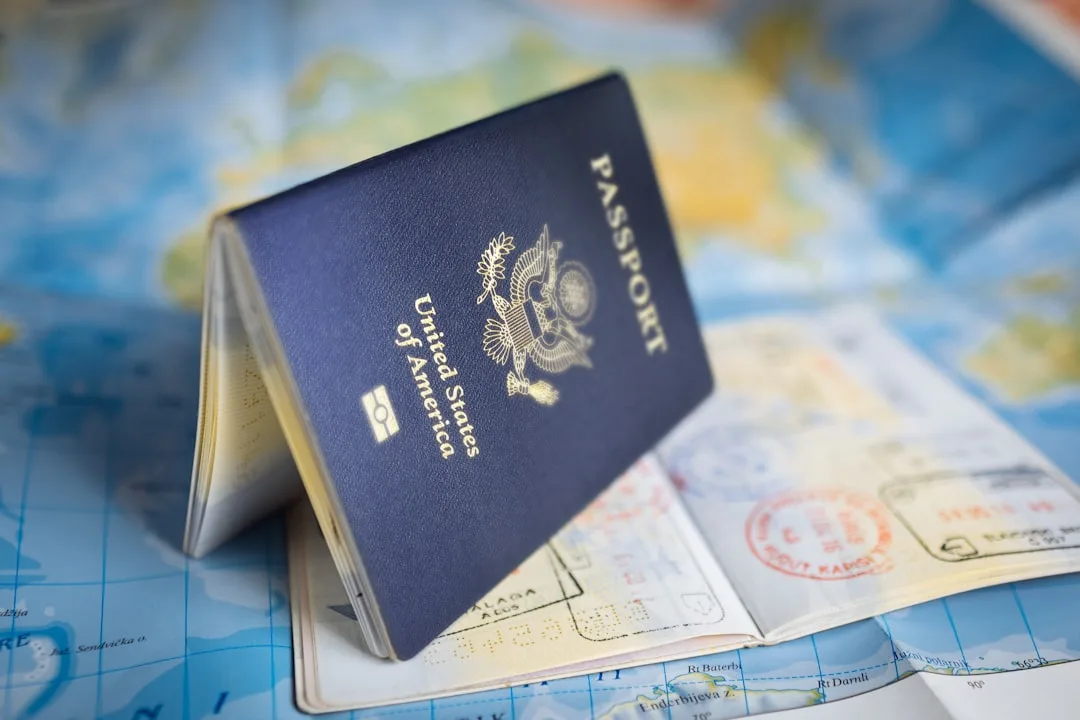 Passport lying on a world map with entry stamps
