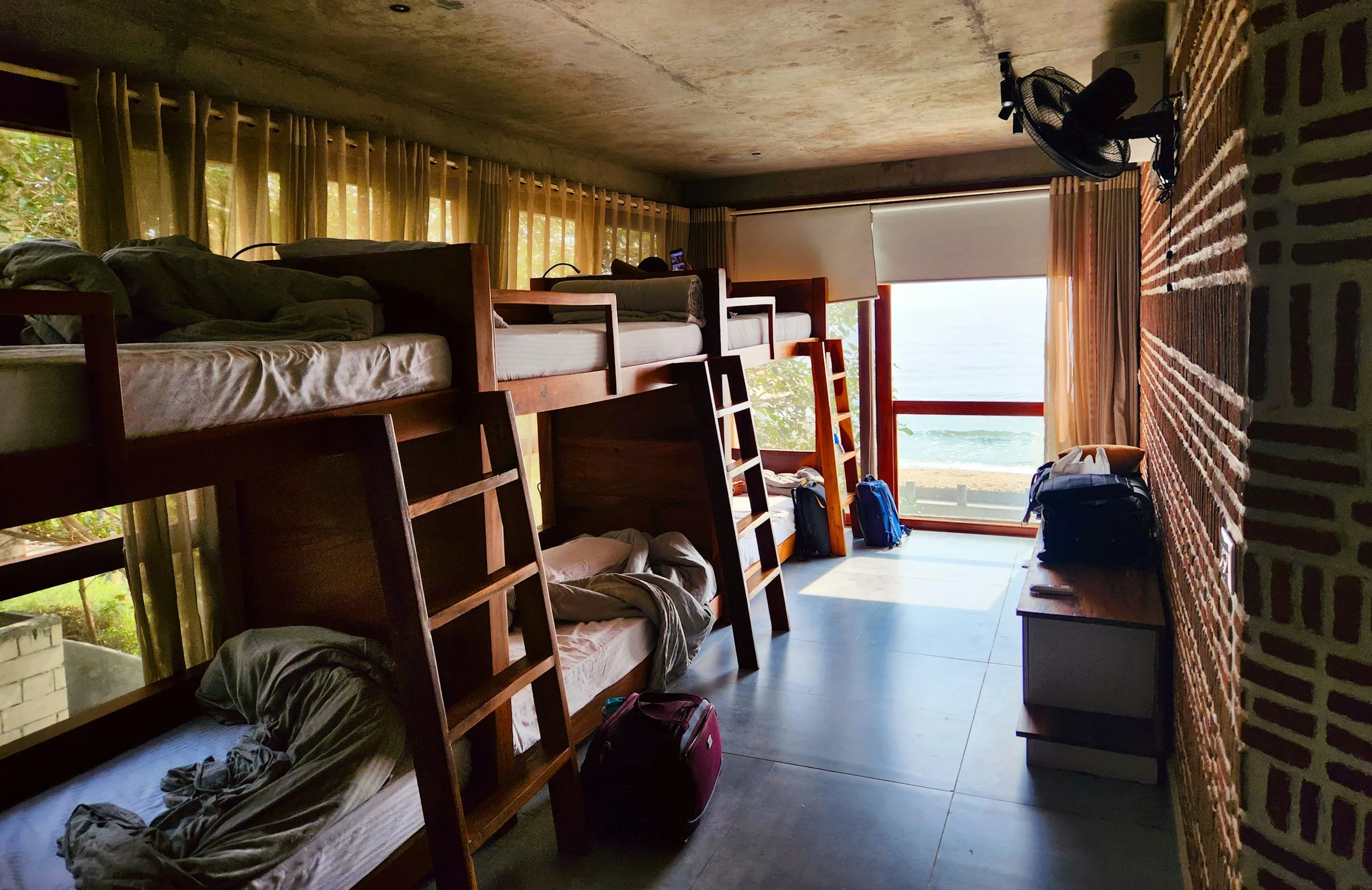 Dormitory room in a hostel with bunk beds and daylight, typical budget accommodation for backpackers