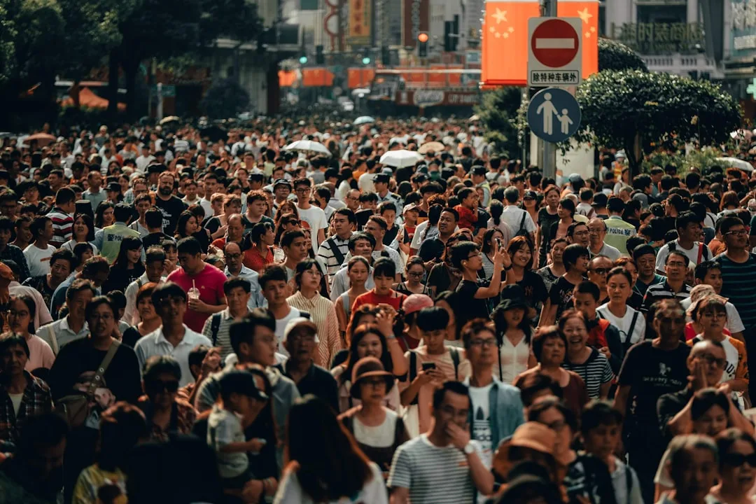 Dense crowd of tourists on a busy city street – symbol for overtourism at popular travel destinations